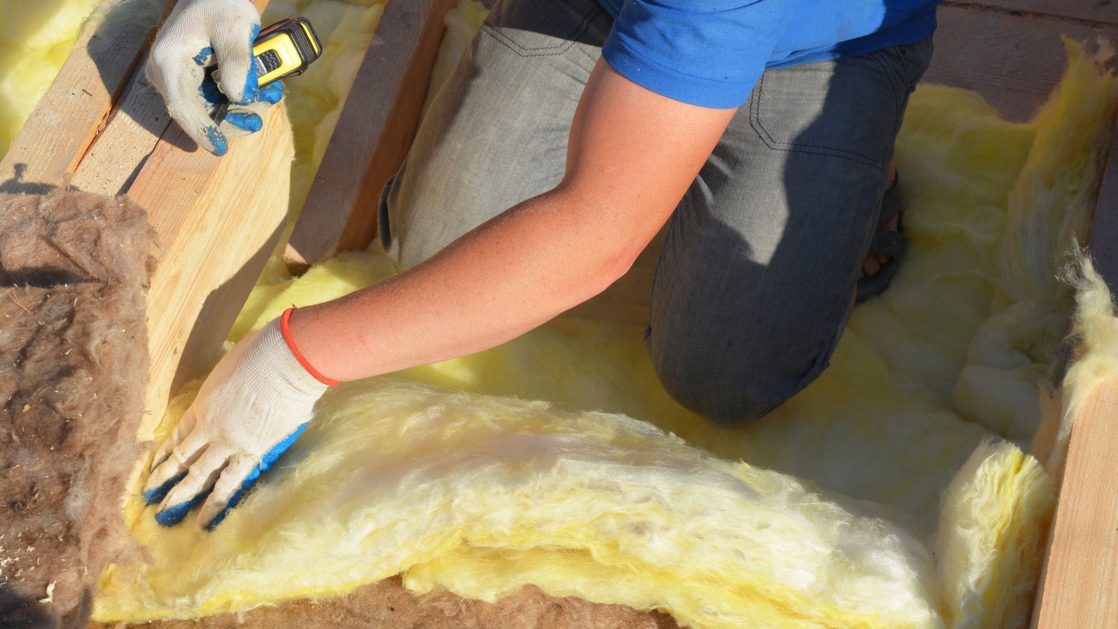 Person laying loft insulation